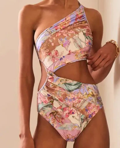 Rose gold patterned women's one-piece swimsuit on a hanger.