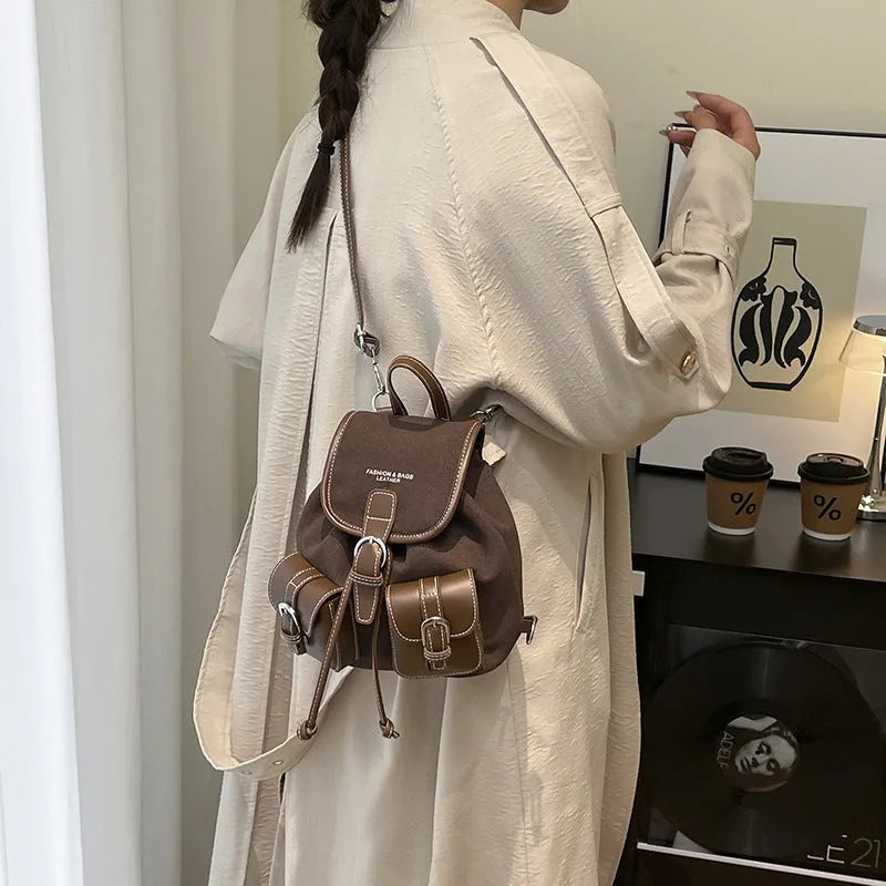 Urban simplicity PU backpack in brown with contrast stitching and clamshell opening, on a flat surface