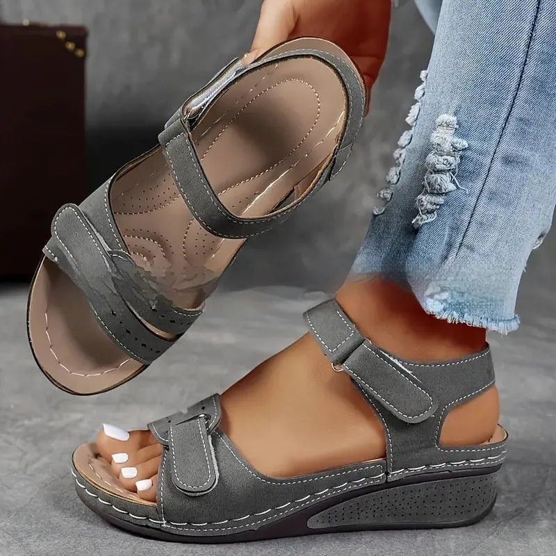 Women's beige plus size sandals with a thick composite sole and an adjustable Velcro strap fastener.