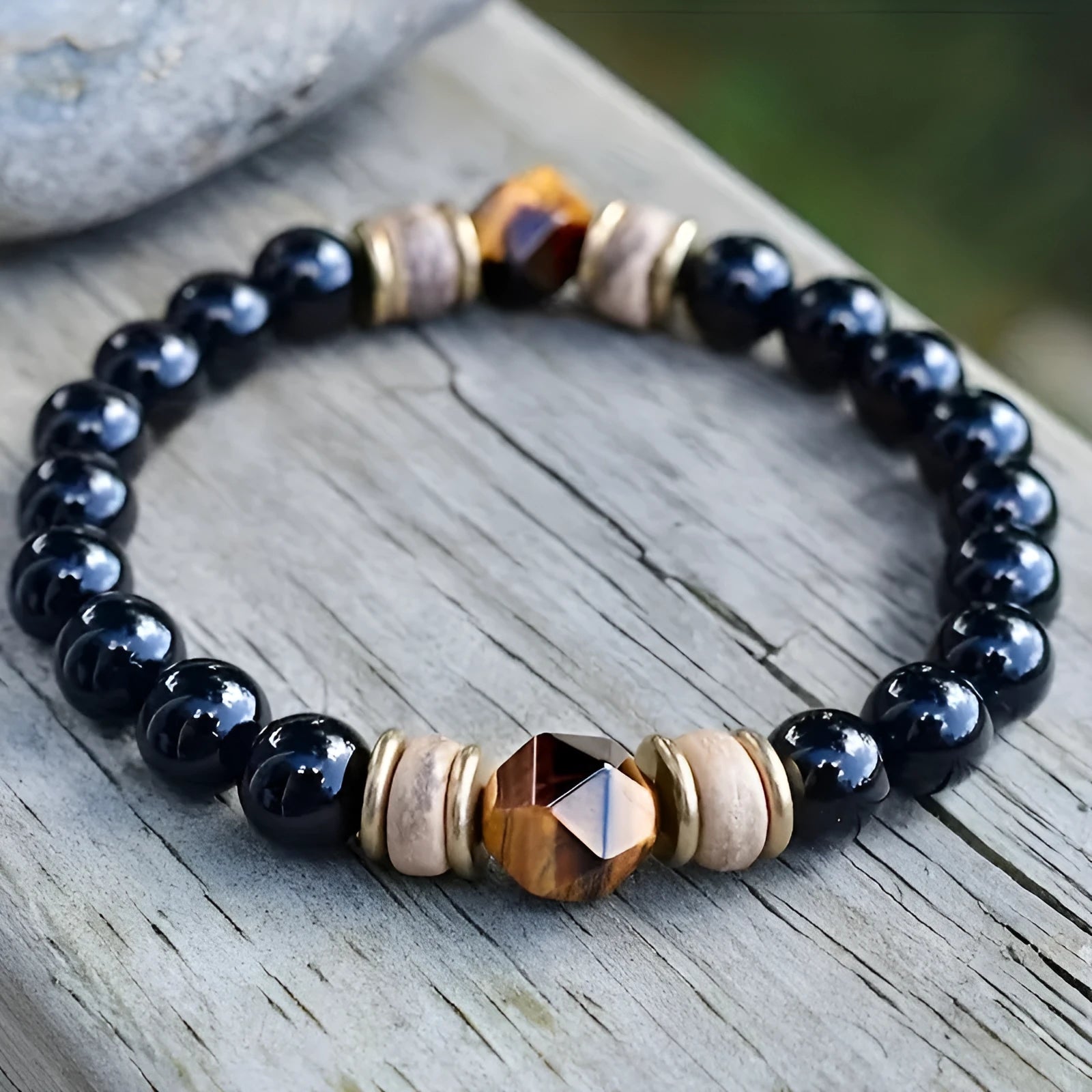Tigereye cut obsidian bracelet with 8mm black beads on neutral background