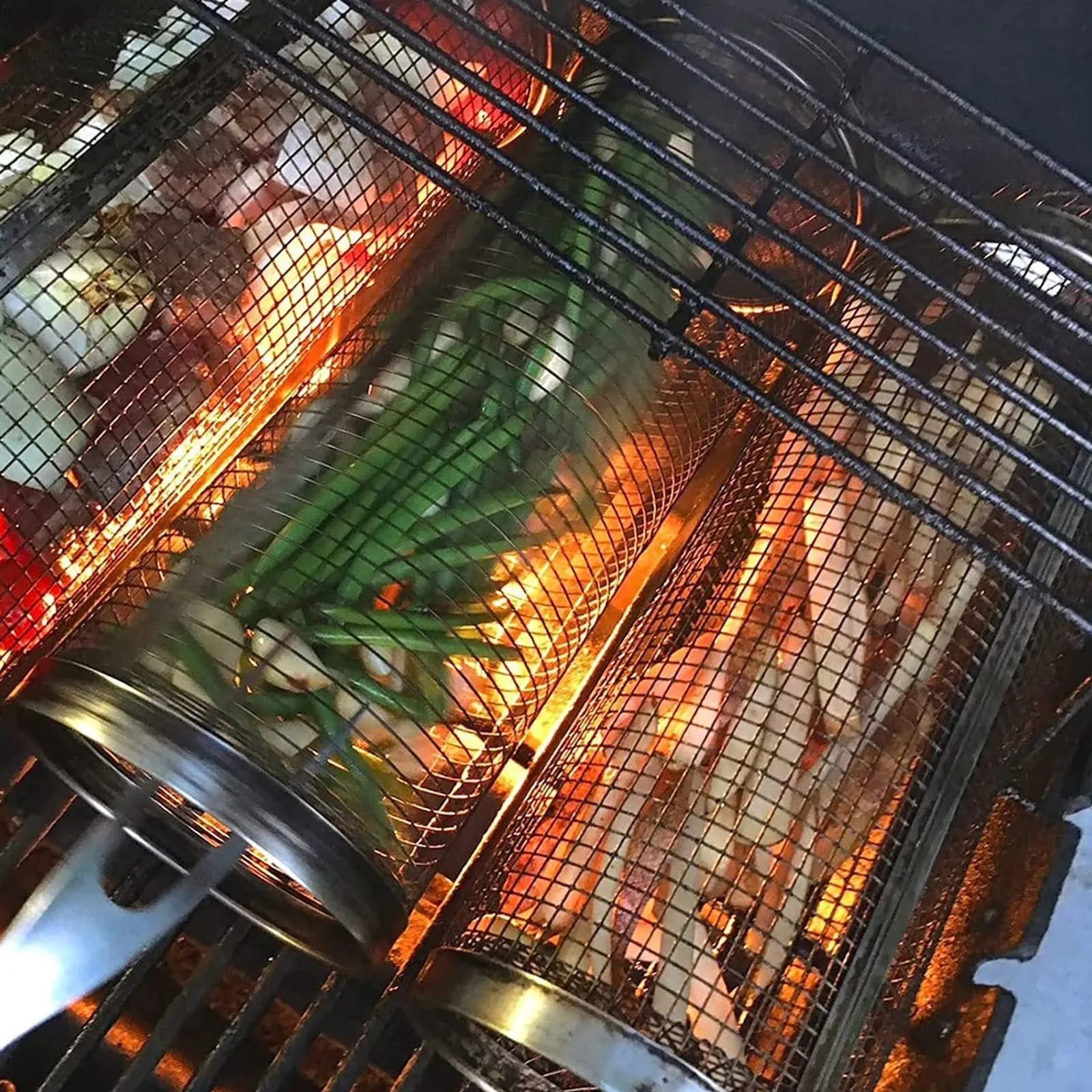 Round rolling metal barbecue grill basket with mesh sides and a handling hook, shown with BBQ gloves.