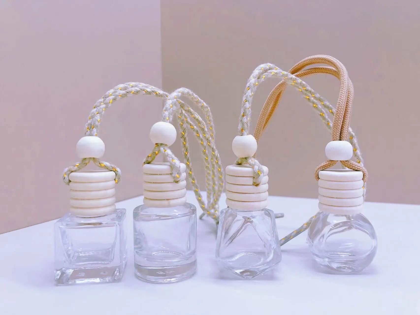 Car perfume pendant in glass bottle showing cylinder, diamond, flat drum and square style options