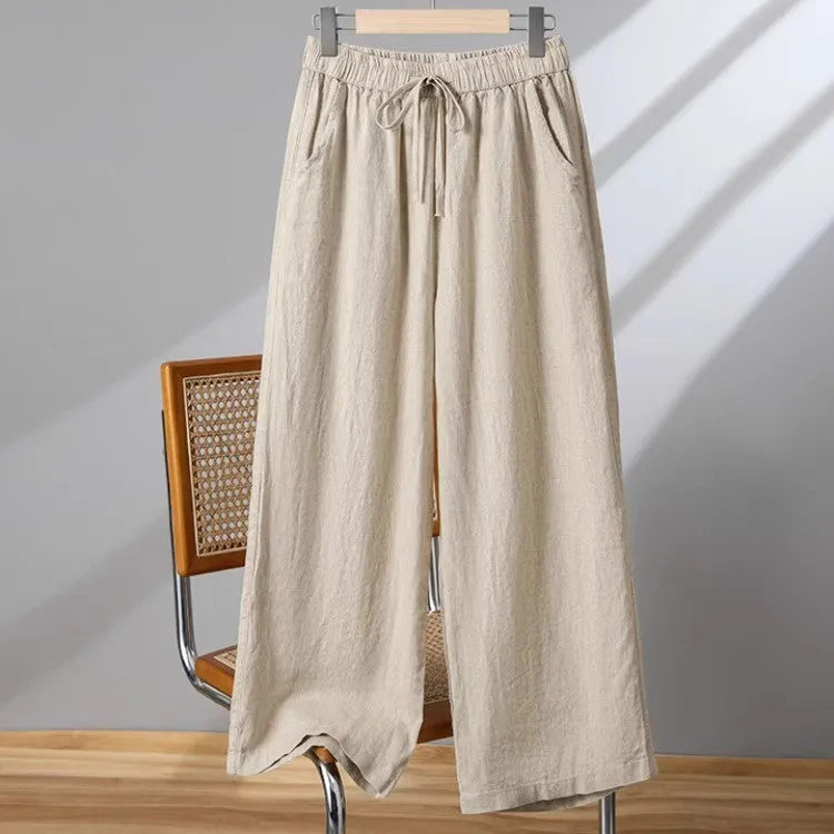 Women's straight leg casual trousers in apricot colour with an elastic waistband and lace-up drawstring detail.