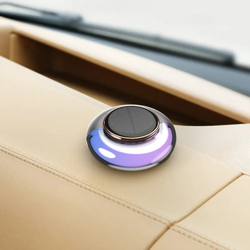 Car solar charging fragrance with built-in motor, round shape, grey colour, on car dashboard