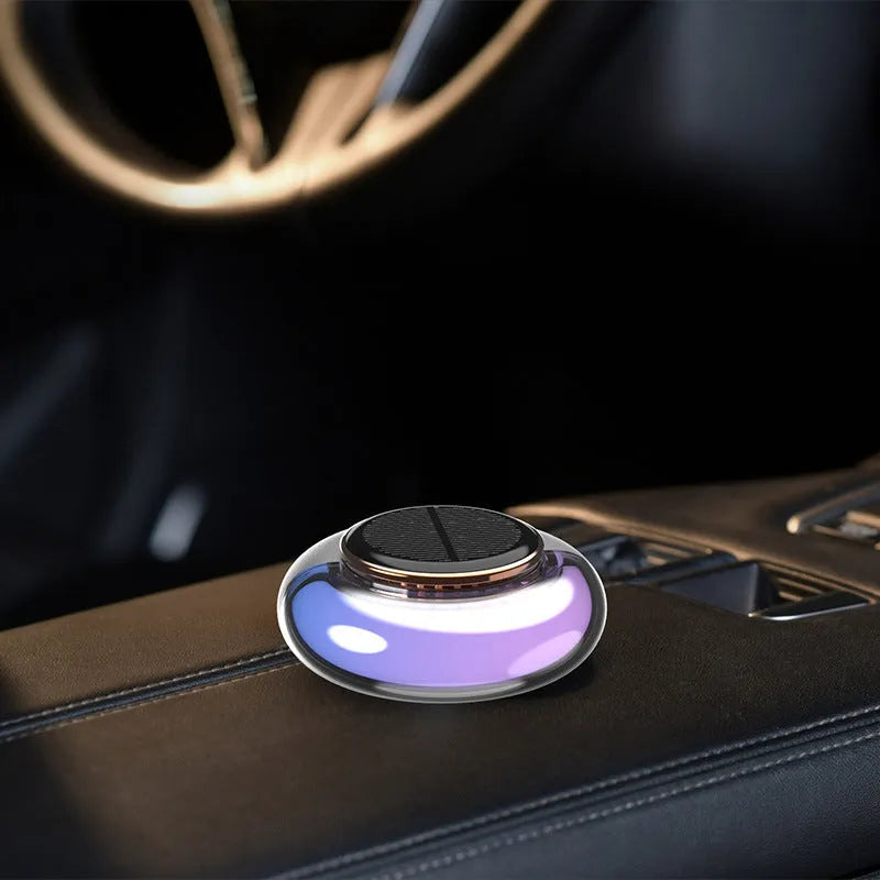 Car solar charging fragrance with built-in motor, round shape, grey colour, on car dashboard