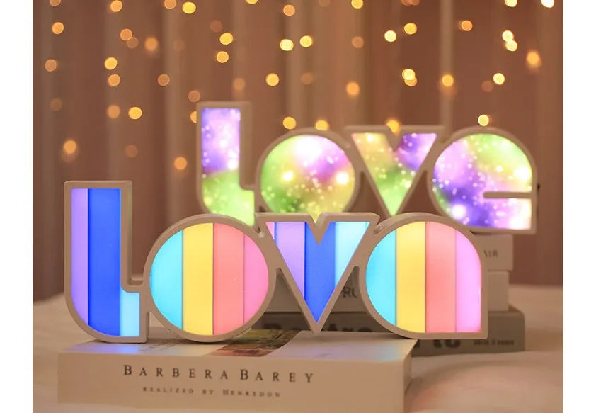Rainbow-style plastic LED LOVE light decoration for Valentine's Day and weddings.