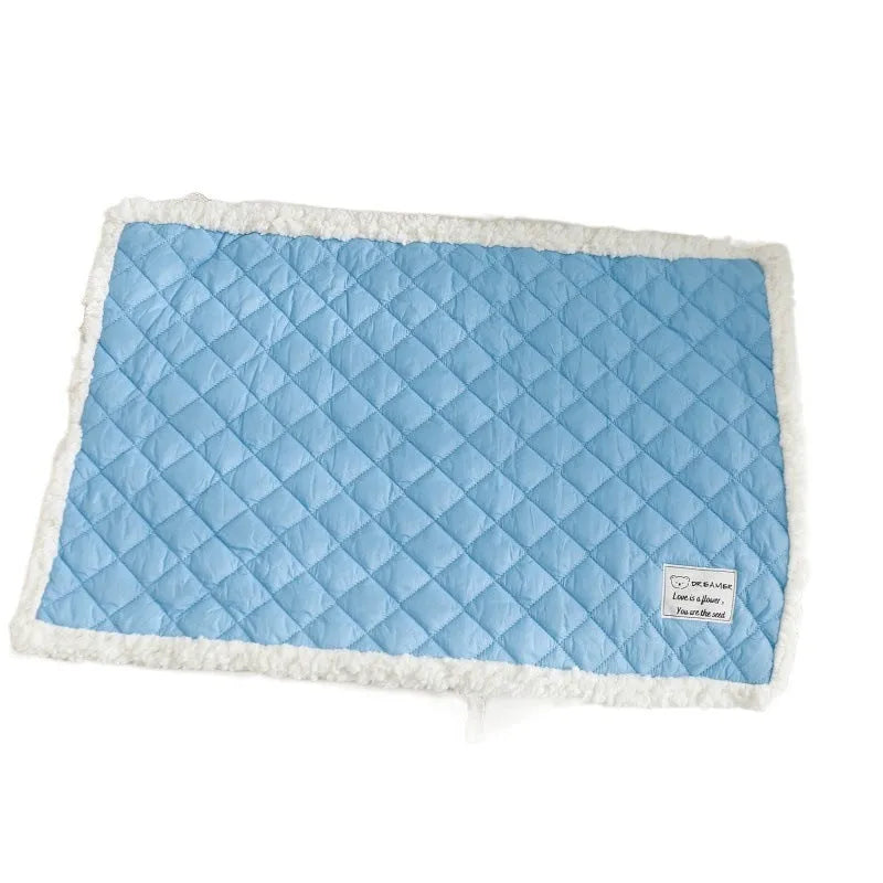 Quilted terry cloth cat blanket in blue, shown alongside pink, yellow, and grey colour options.
