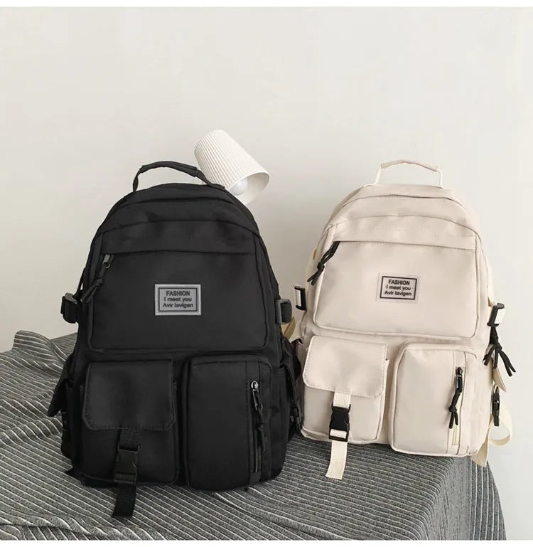 Black or white nylon student backpack with computer compartment measuring 31x12x41cm