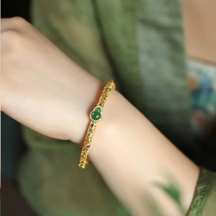 Gold-plated women's open cuff bracelet with xiangyun gourd charm on copper electroplated construction