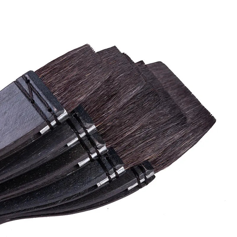 Squirrel hair makeup brush with natural wood handle on a clean surface.