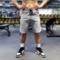 Men's thin quick-drying running shorts in black, blue, or grey, made from nylon and spandex.