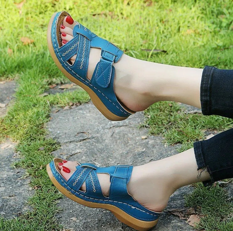 Women's red peep toe wedge sandals with a Velcro strap and hollow wedge heel.