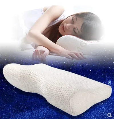 Blue butterfly-shaped memory foam cervical pillow on a bed.