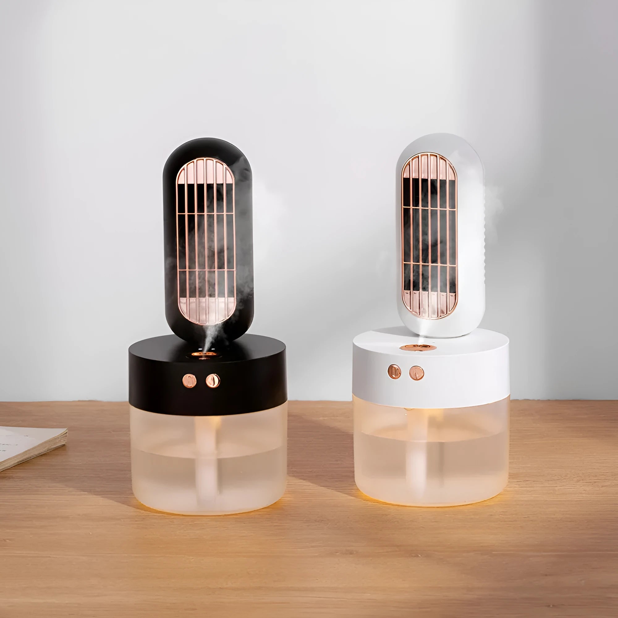 Small black and white humidifier fan with an oscillating head on a desk.