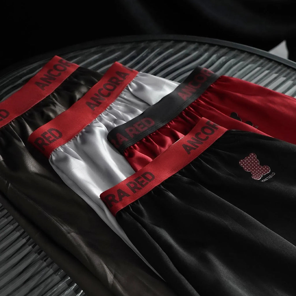Men's solid colour boxer briefs in black on a mid-waist model.
