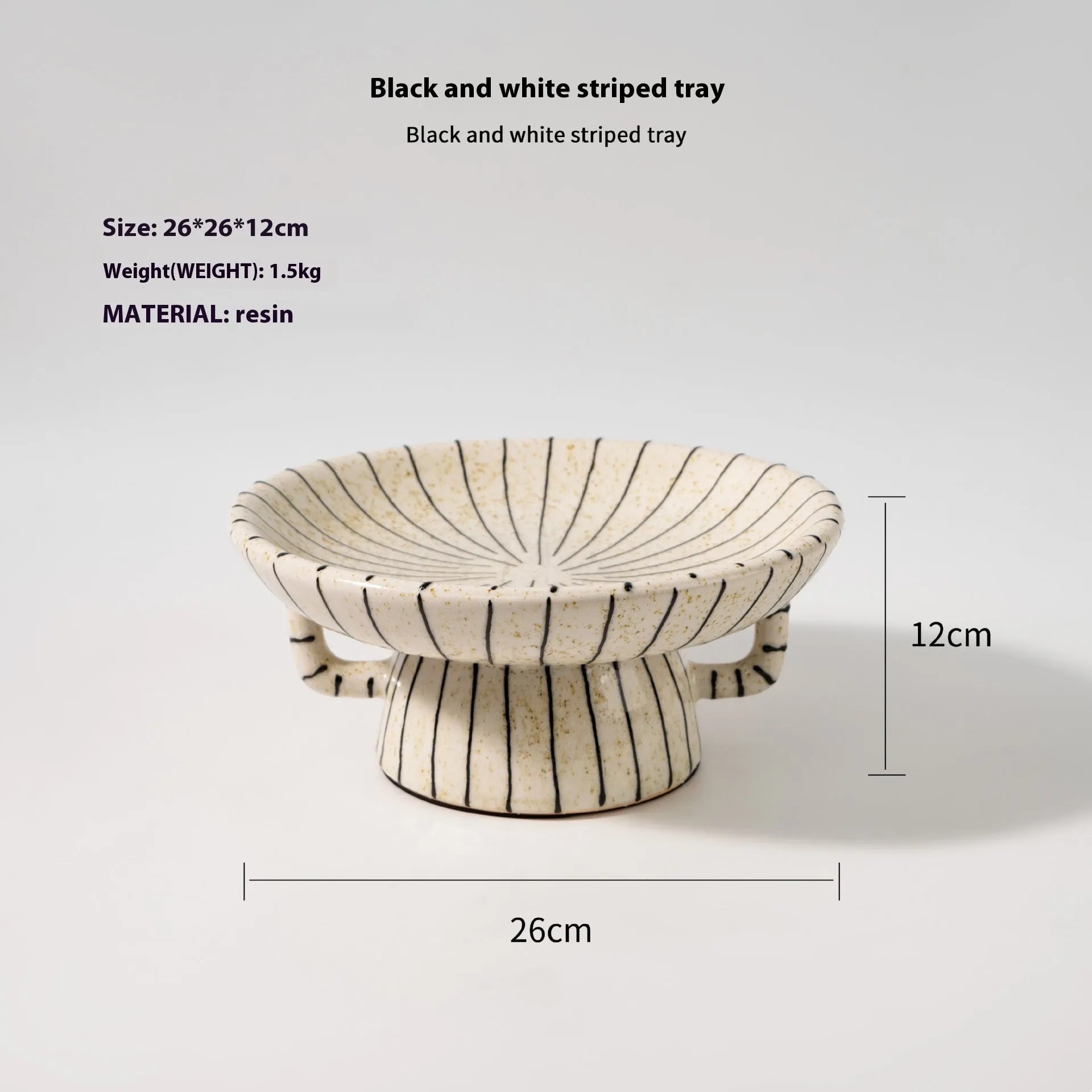 Black and white striped synthetic resin fruit plate on a plain surface.