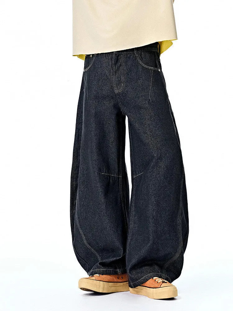 Men's wide leg denim trousers in original cow colour, showing mid-waist and relaxed fit.