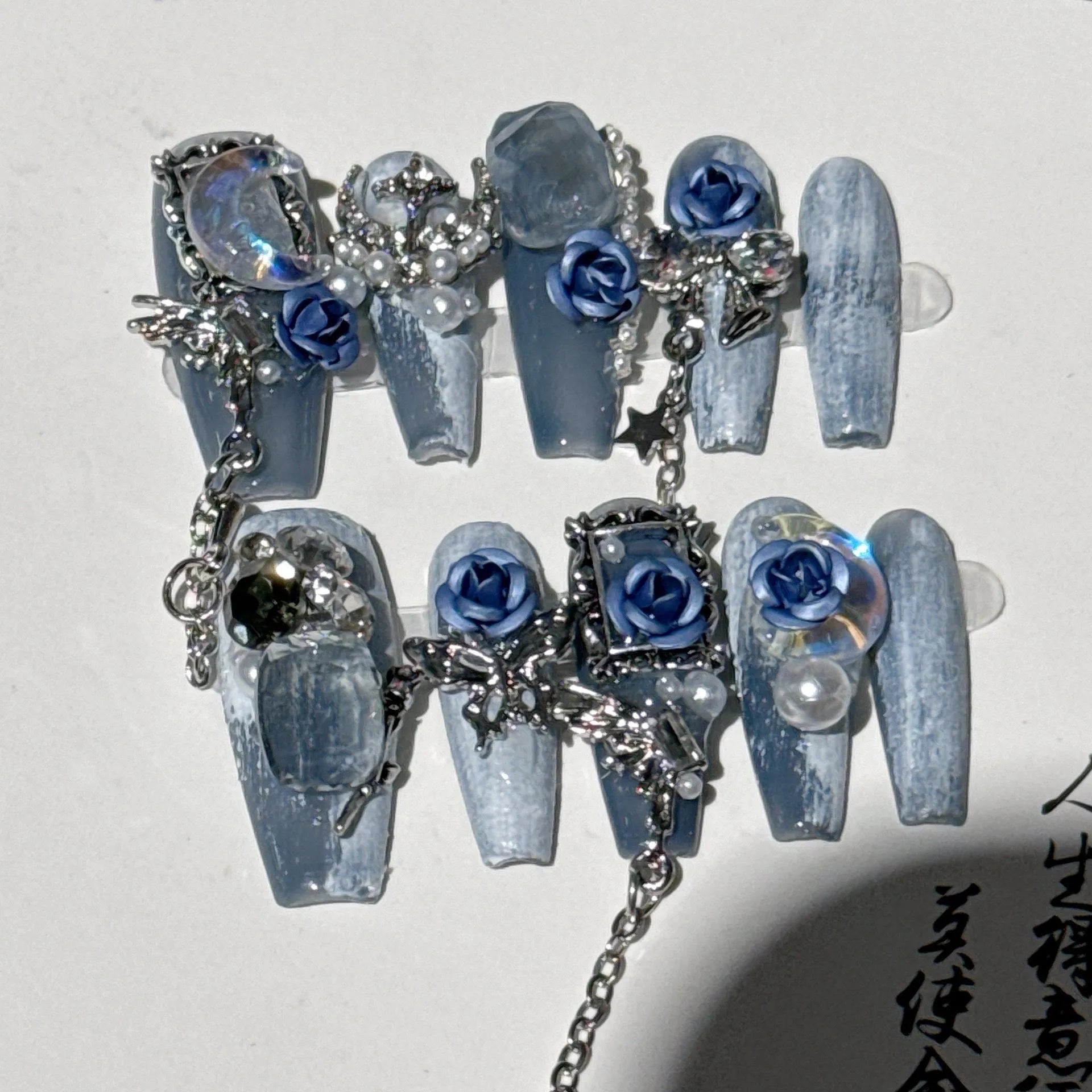 Evening manicure set with rose and tulip patterns in night blue colour featuring plastic armour suit
