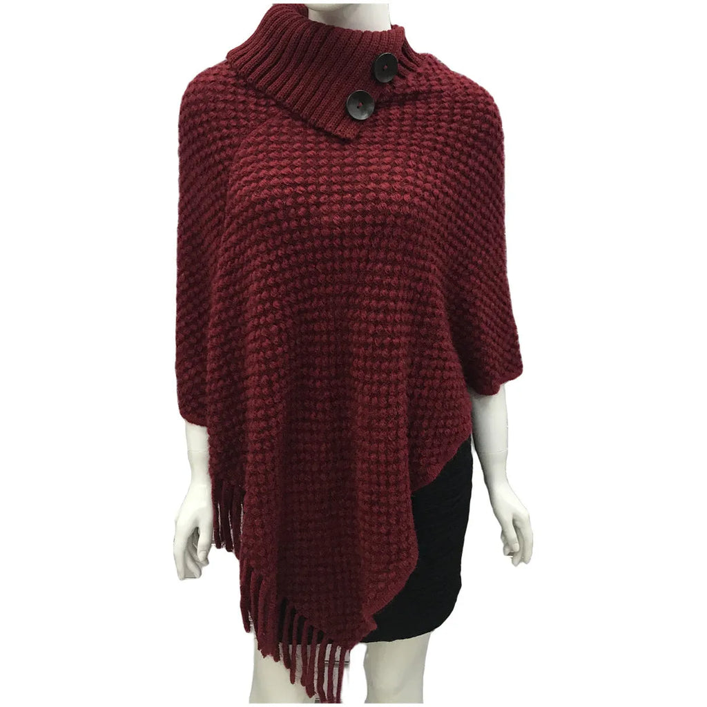 Sleeveless knitted cloak shawl with dot pattern, shown in apricot colour
