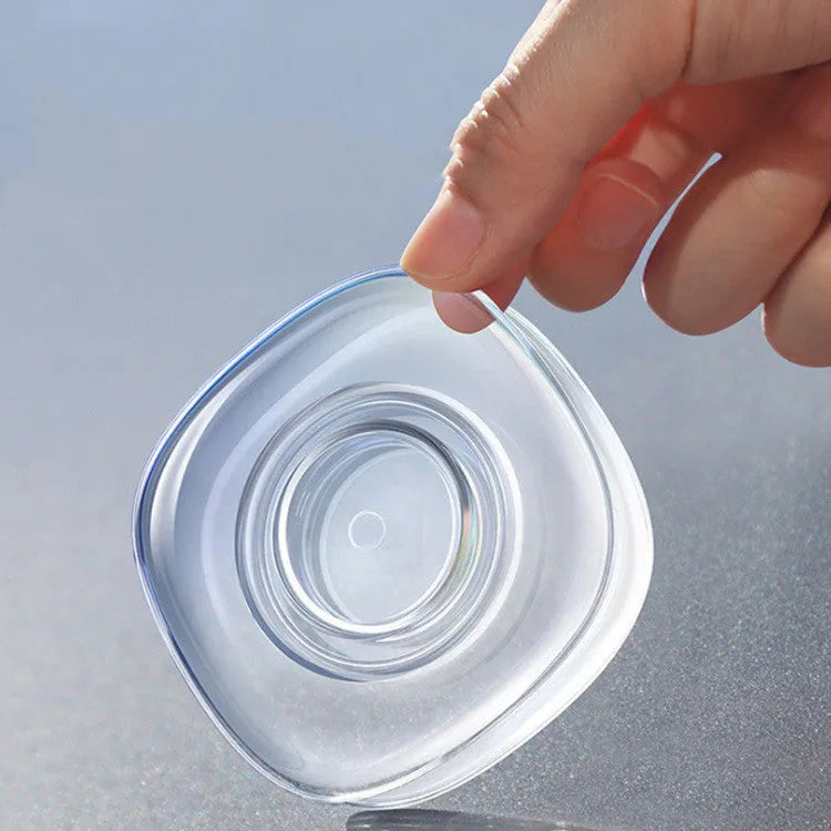 Transparent reusable nano gel adhesive pads in circular and square shapes on a smooth surface
