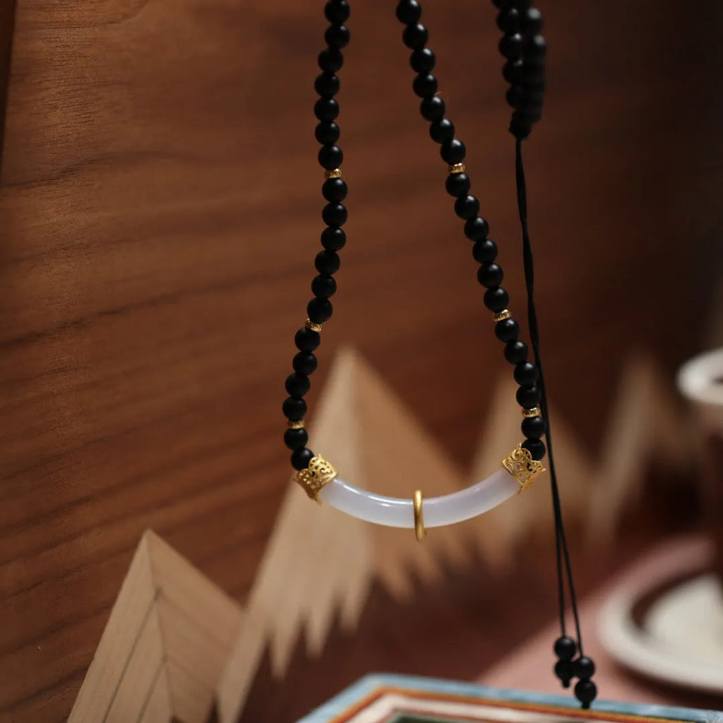 Natural frosted black agate and white chalcedony necklace with silver pendant on ball bead chain.