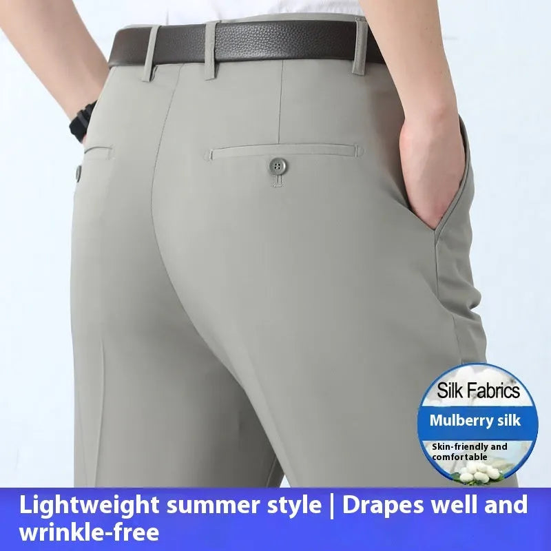 Man wearing dark blue straight-cut high-waist business trousers made from a mulberry silk blend.