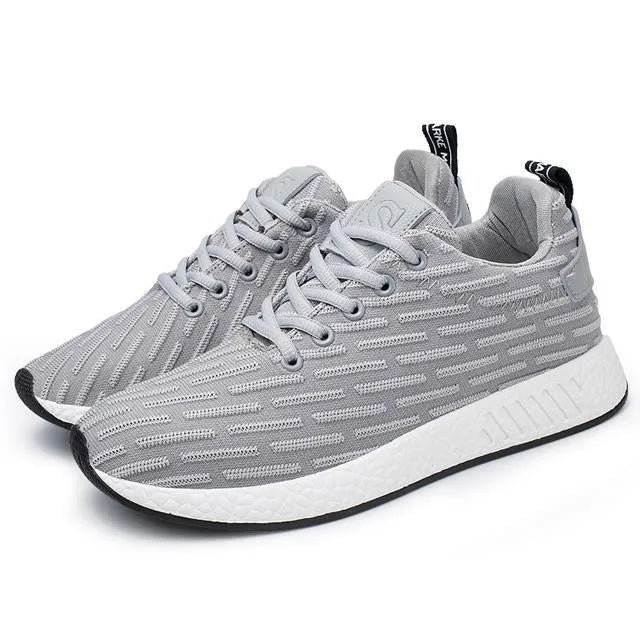 Men Malcolm Sneaker in black from side view showing mesh fabric upper and low-top design