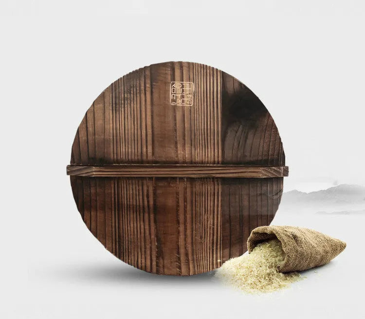 Black traditional iron wok with wooden handle, shown with glass lid.