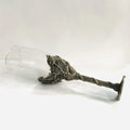 Alloy dinosaur champagne glass goblet in ancient tin colour on a surface, 21cm tall, retro style