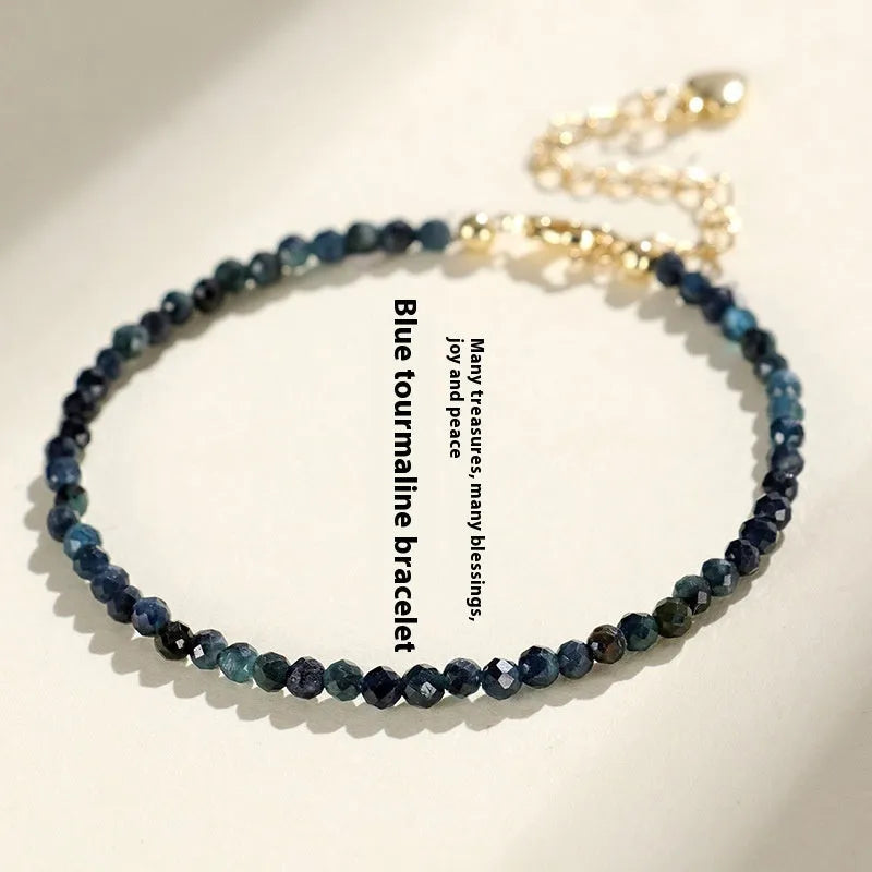Blue tourmaline beaded bracelet with spacer beads on wrist showing 3mm gemstone size
