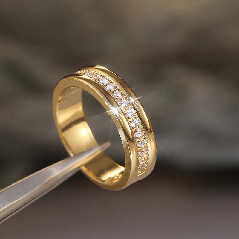 Gold-plated copper geometric ring with inlaid zircon on white background