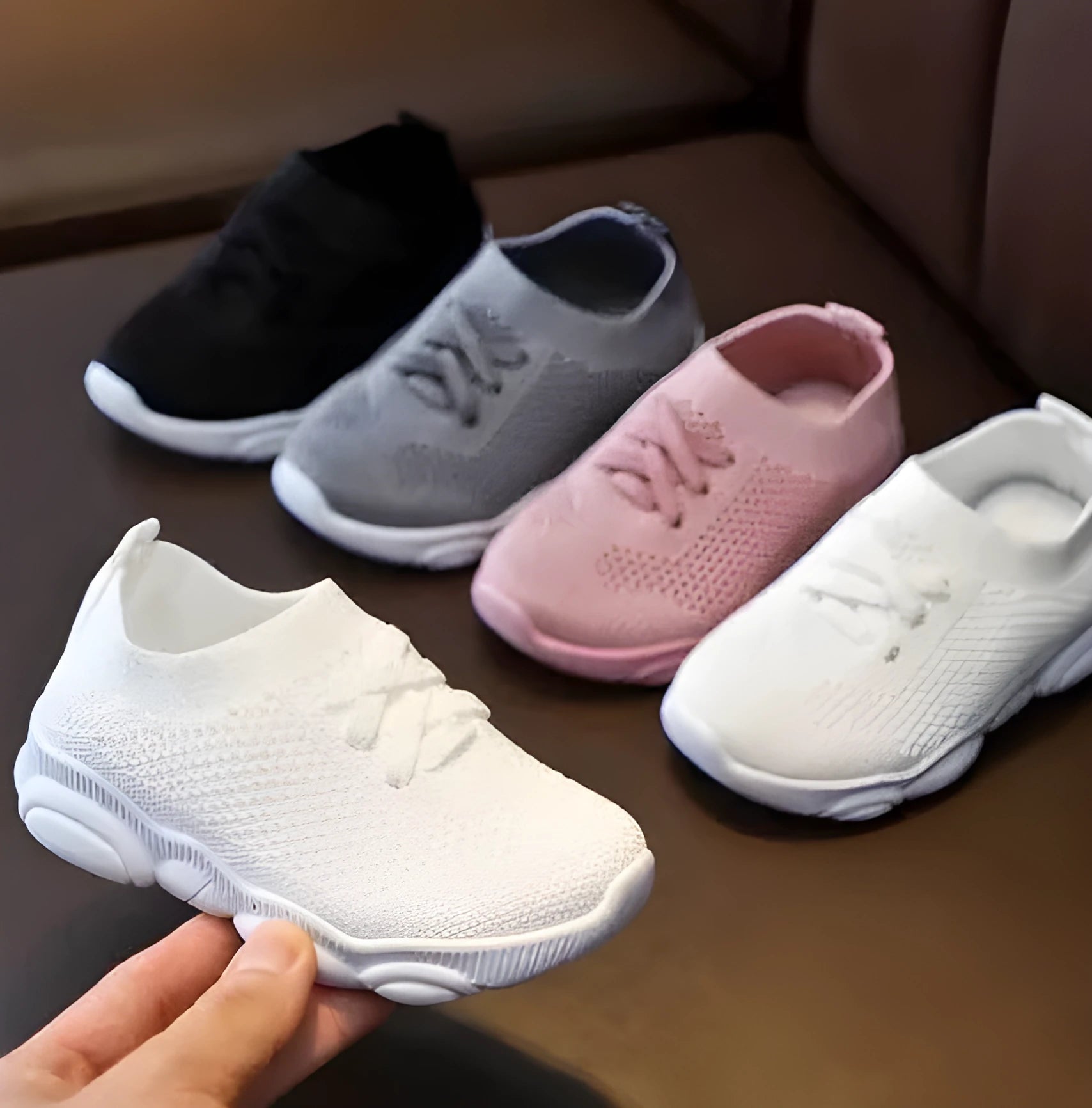 Children's white fabric lazy shoe with a non-slip rubber sole, shown on a foot.