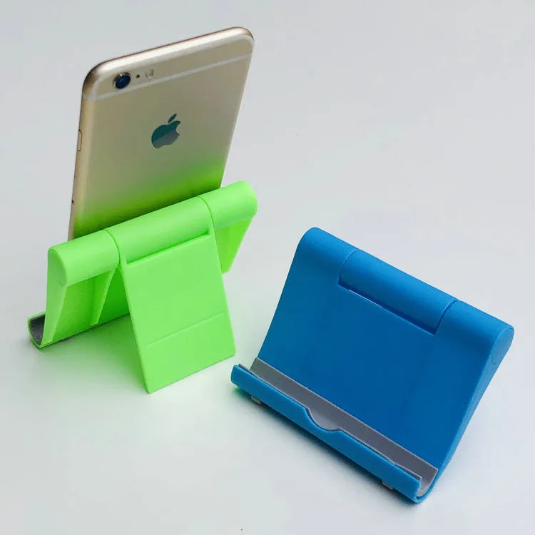 Folding phone and tablet stand in PP and TPR, about 10cm by 8cm by 2cm, in eight colours