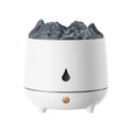 White volcano-shaped ultrasonic humidifier with USB cable on table emitting mist