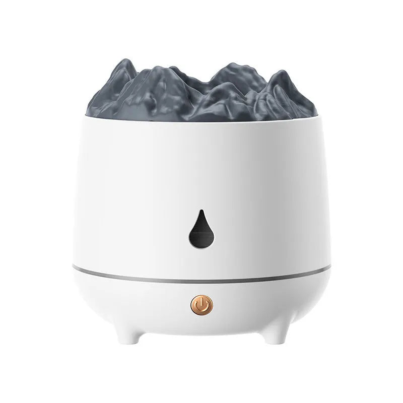 White volcano-shaped ultrasonic humidifier with USB cable on table emitting mist
