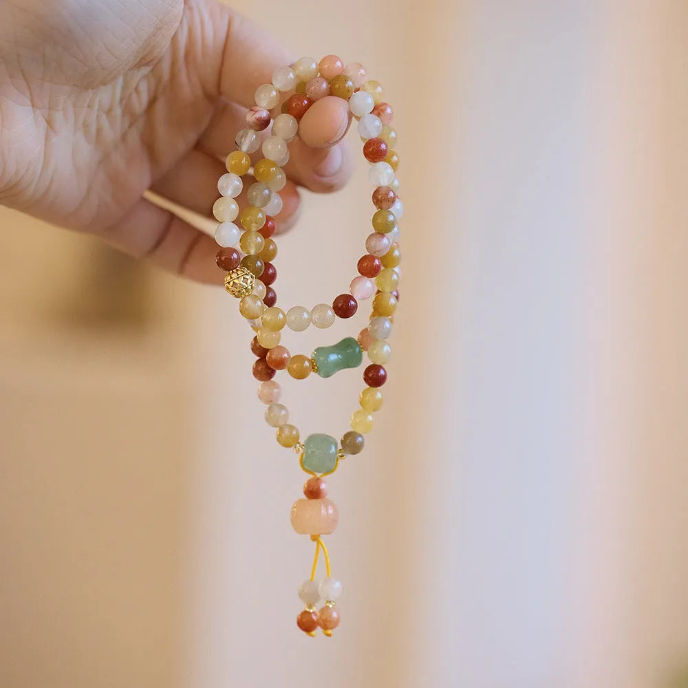 Women's Jinsi Jade bracelet with three pumpkin beads and tassel decoration on wrist