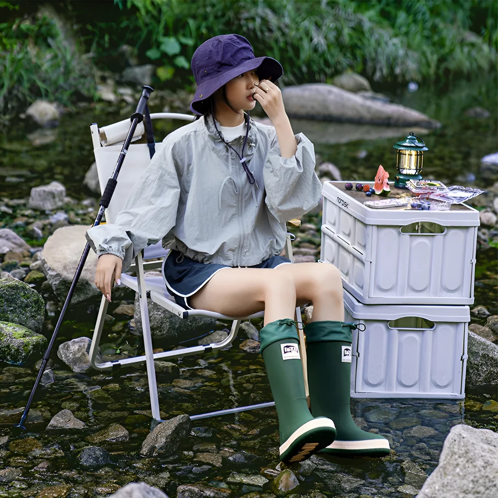 A pair of high tube PVC rain boots in a solid colour, shown on a non-slip sole.