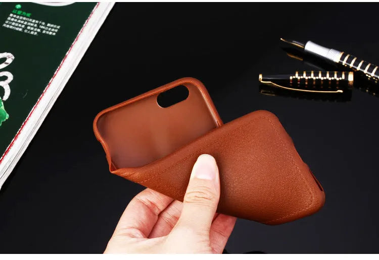 Leather and TPU iPhone case in black, shown on an iPhone.