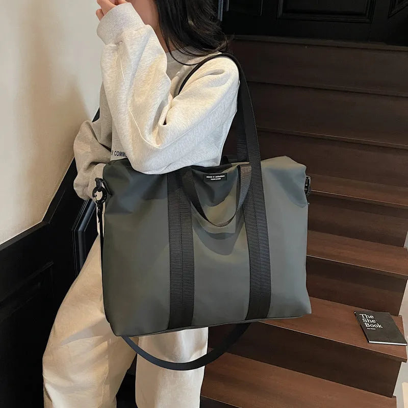 Lightweight Oxford cloth tote bag in black colour with 20-35L capacity for travel storage