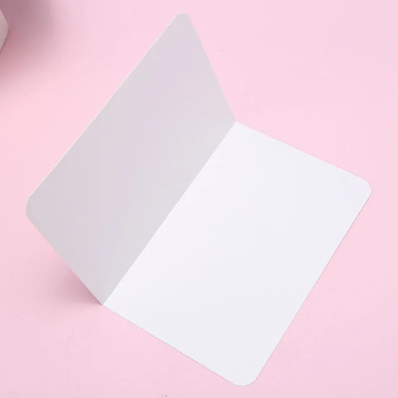 Pack of 100 blank folded kraft paper cards in 10x15 cm size, shown in black, brown, and white colours.