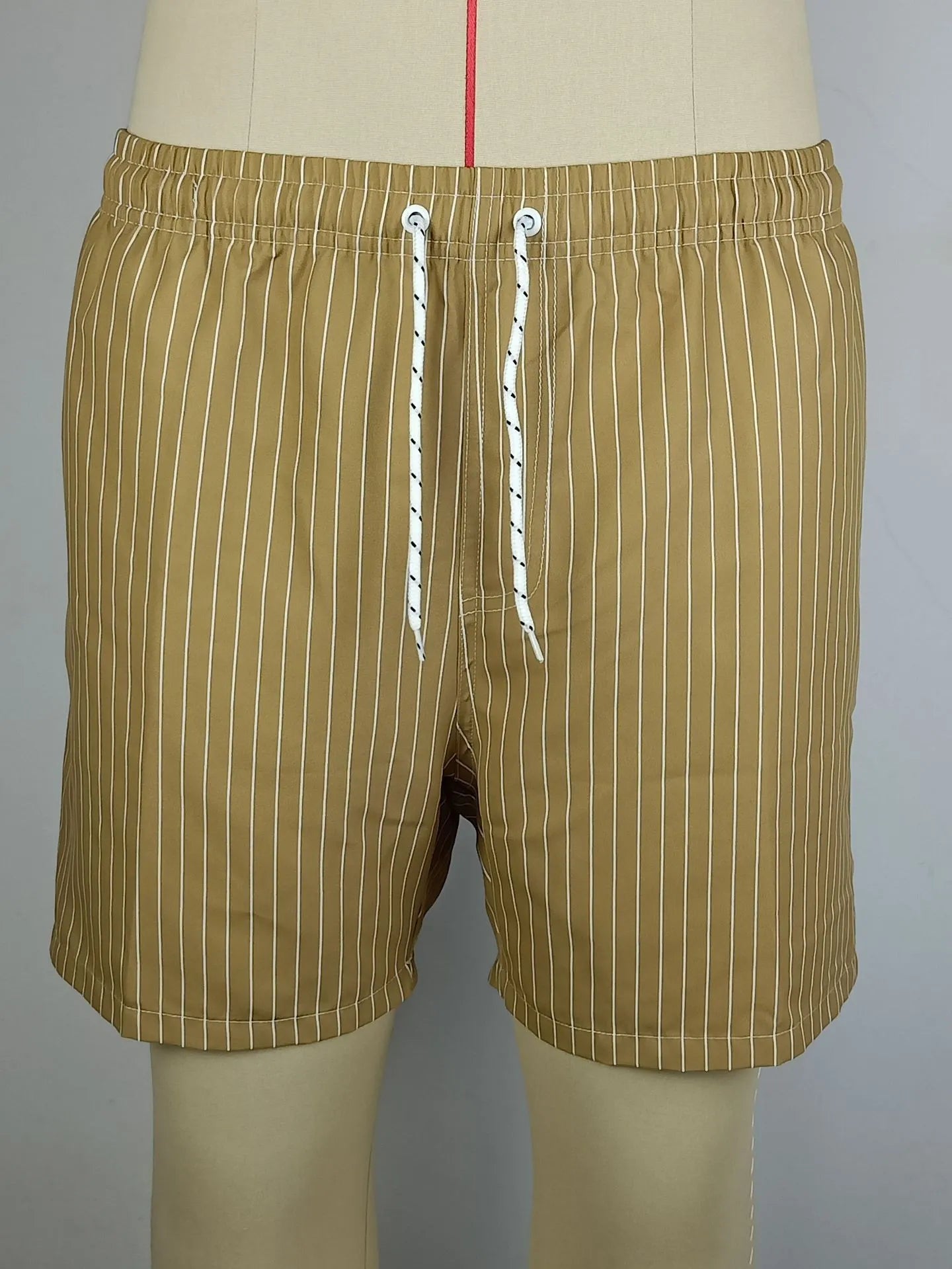Men's polyester beach shorts with striped triangle pattern in navy blue colour showing straight leg opening