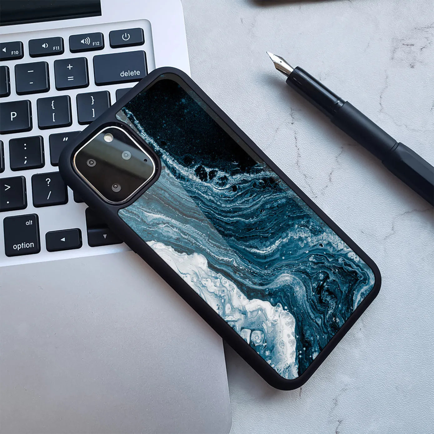 Marble print plastic back cover case for iPhone shown in a blue and gold colour variant.