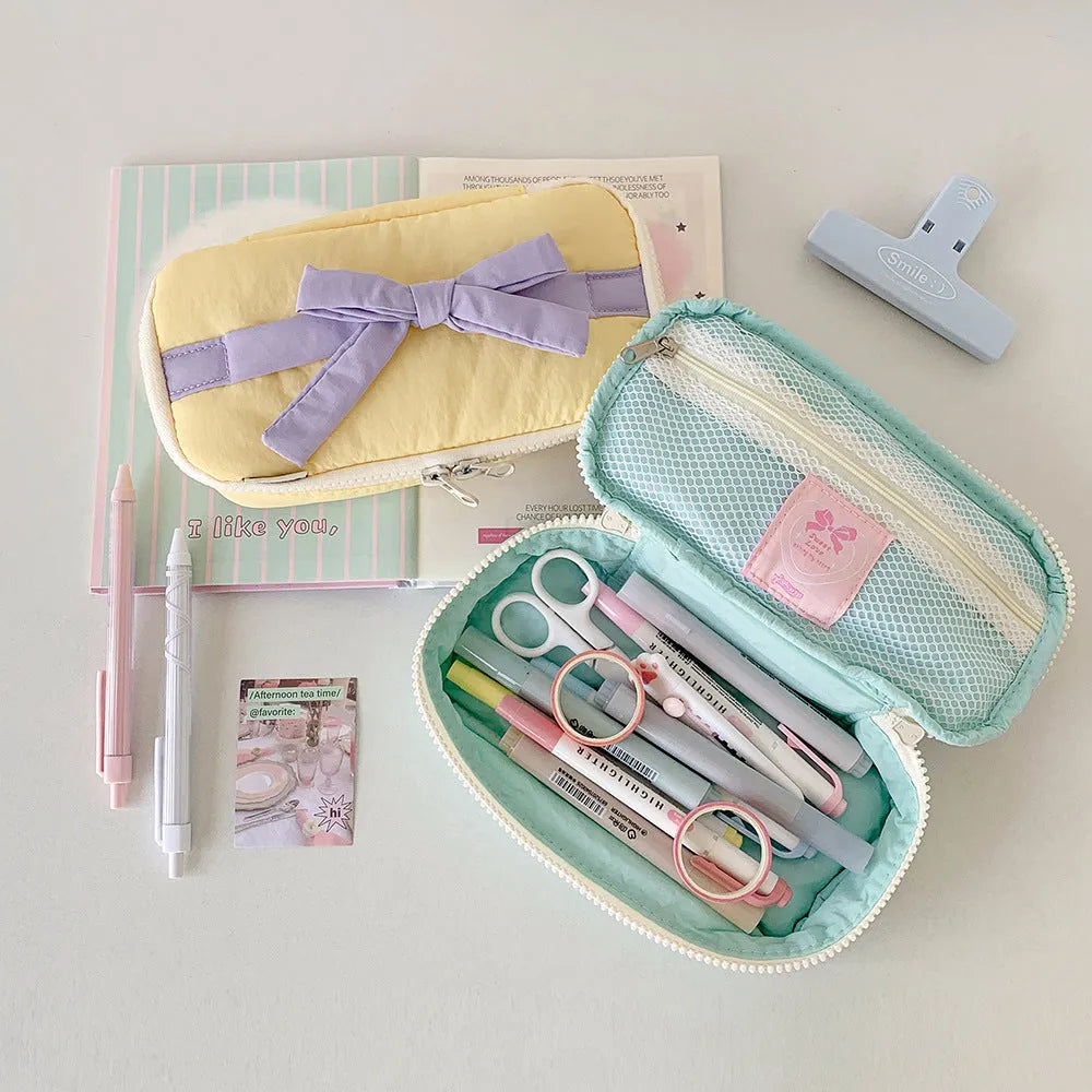 Soft polyester cotton pencil case with minimalist bow design, available in six colours including pink, black and yellow