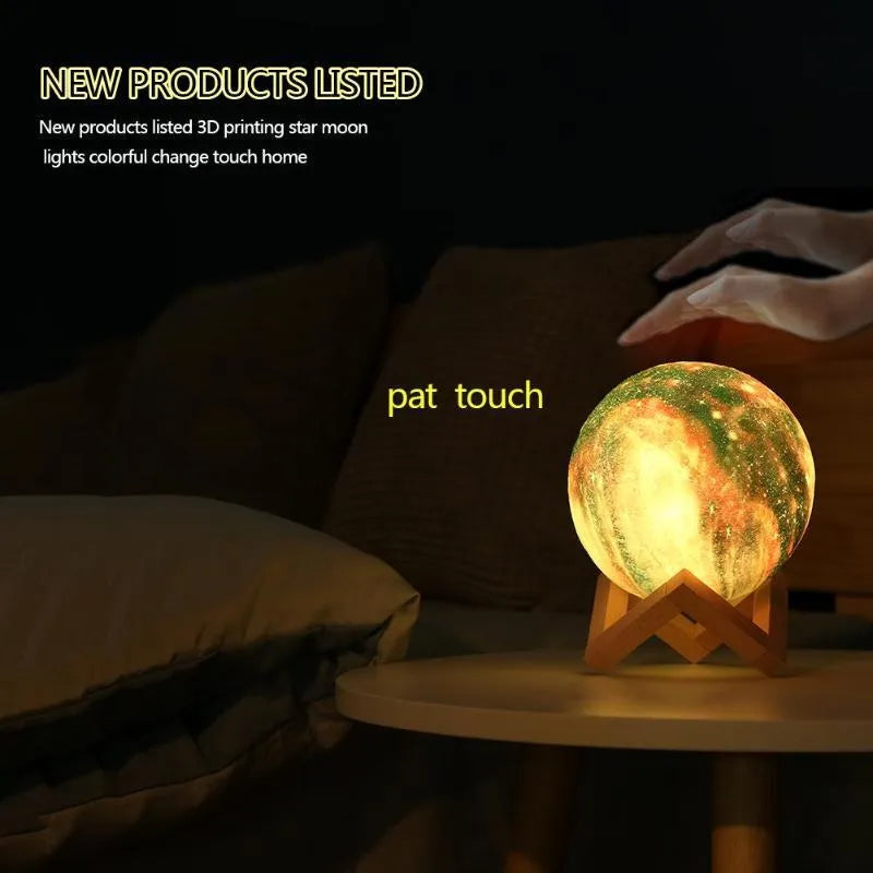 3D-printed spherical lunar night light with remote control on a dark surface.