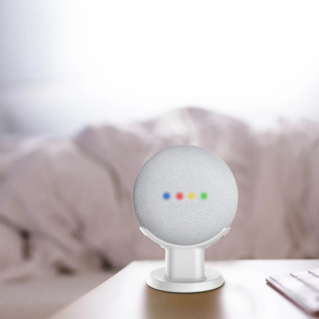 Black plastic stand holder for a Google Home Mini smart speaker on a desk