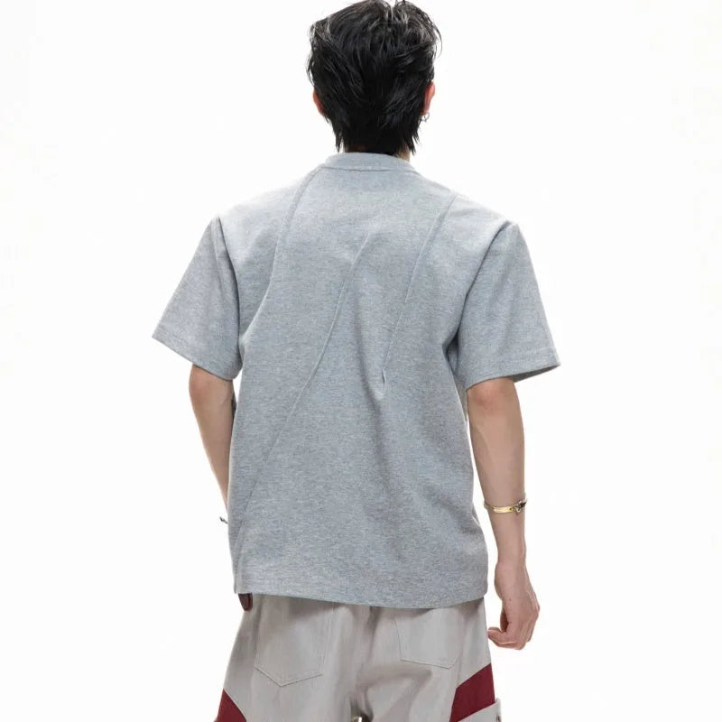 Men's loose fit cotton t-shirt with round neck collar and asymmetrical stitching in black, grey, or white