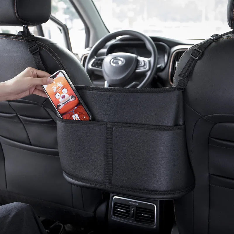 Black leather car seat storage bag with carbon fibre pattern measuring 38cm wide