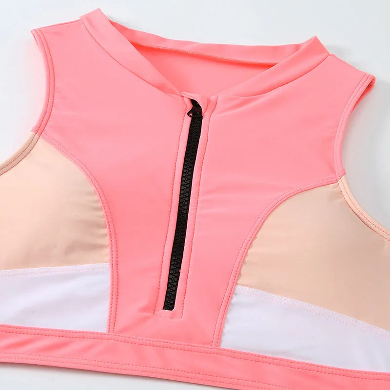 Pink high waist bikini swimsuit set with split design on a solid colour background.