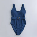 Navy blue one-piece women's swimsuit with a triangle neckline and slimming fit on a mannequin.