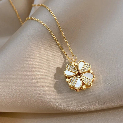 Stainless steel four-leaf clover pendant necklace with crystal heart detail, showcased in various angles and colors